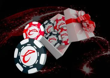 Fichas de casino con el logotipo de Caliente junto a una caja de regalo